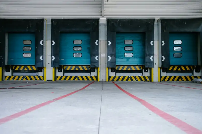 Row of insulated loading-dock doors in a distribution warehouse