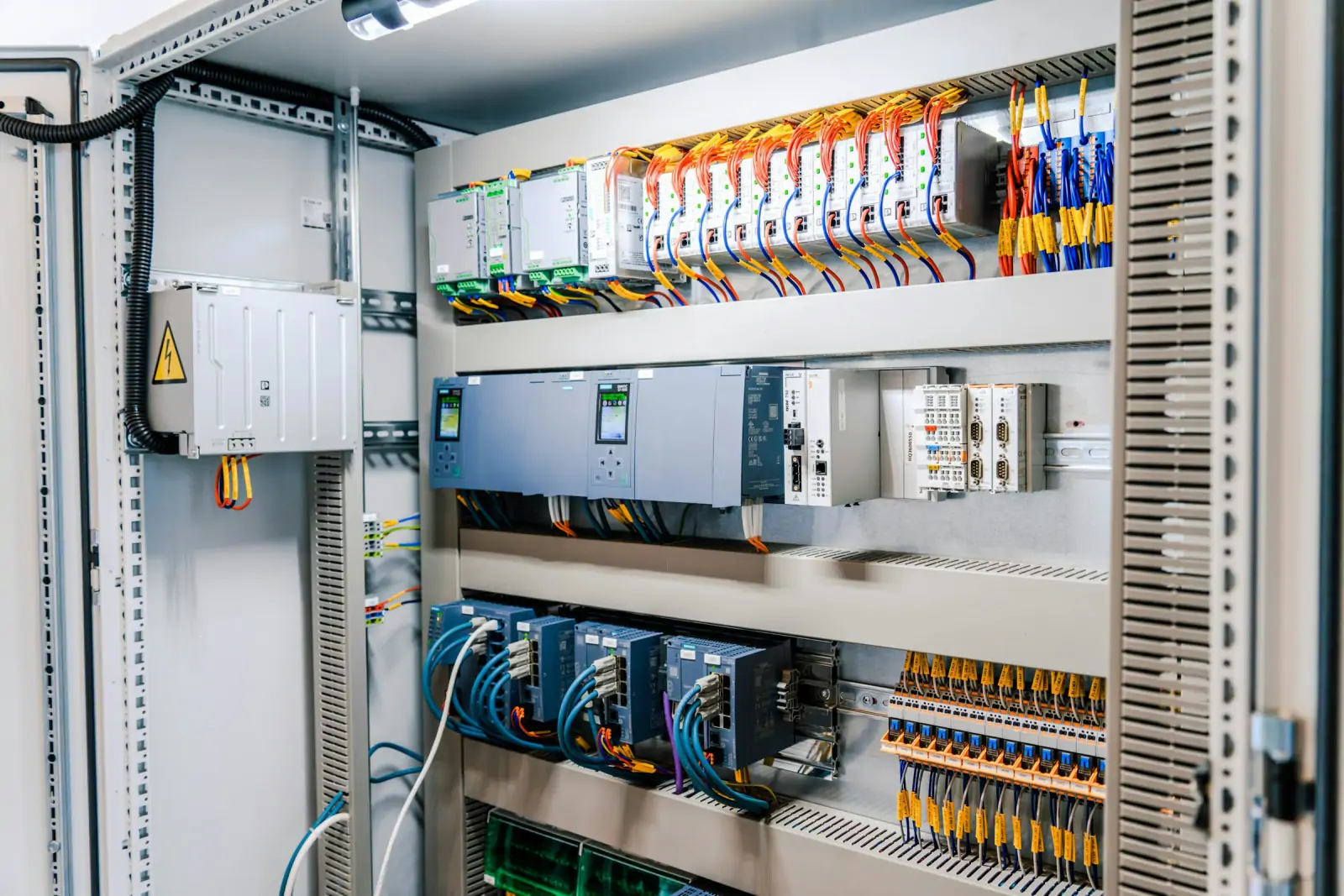 Open electrical control panel with breakers, relays and terminal wiring