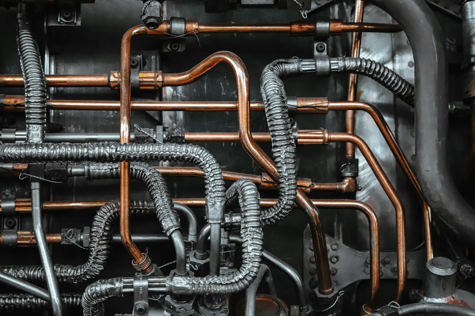Close-up of copper refrigerant lines and flexible hoses on refrigeration equipment