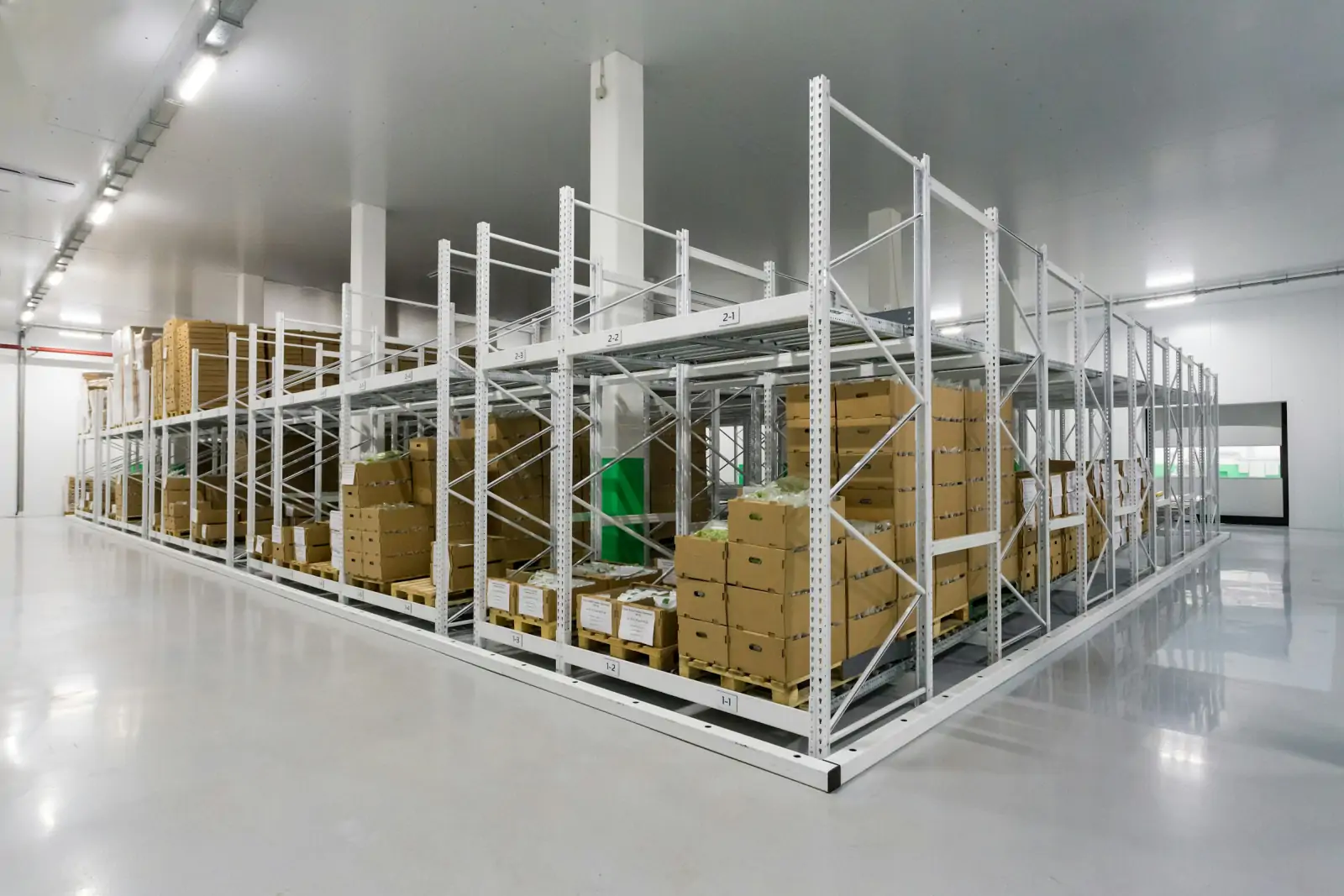 Clean, brightly lit storage room with steel racking and boxed supplies